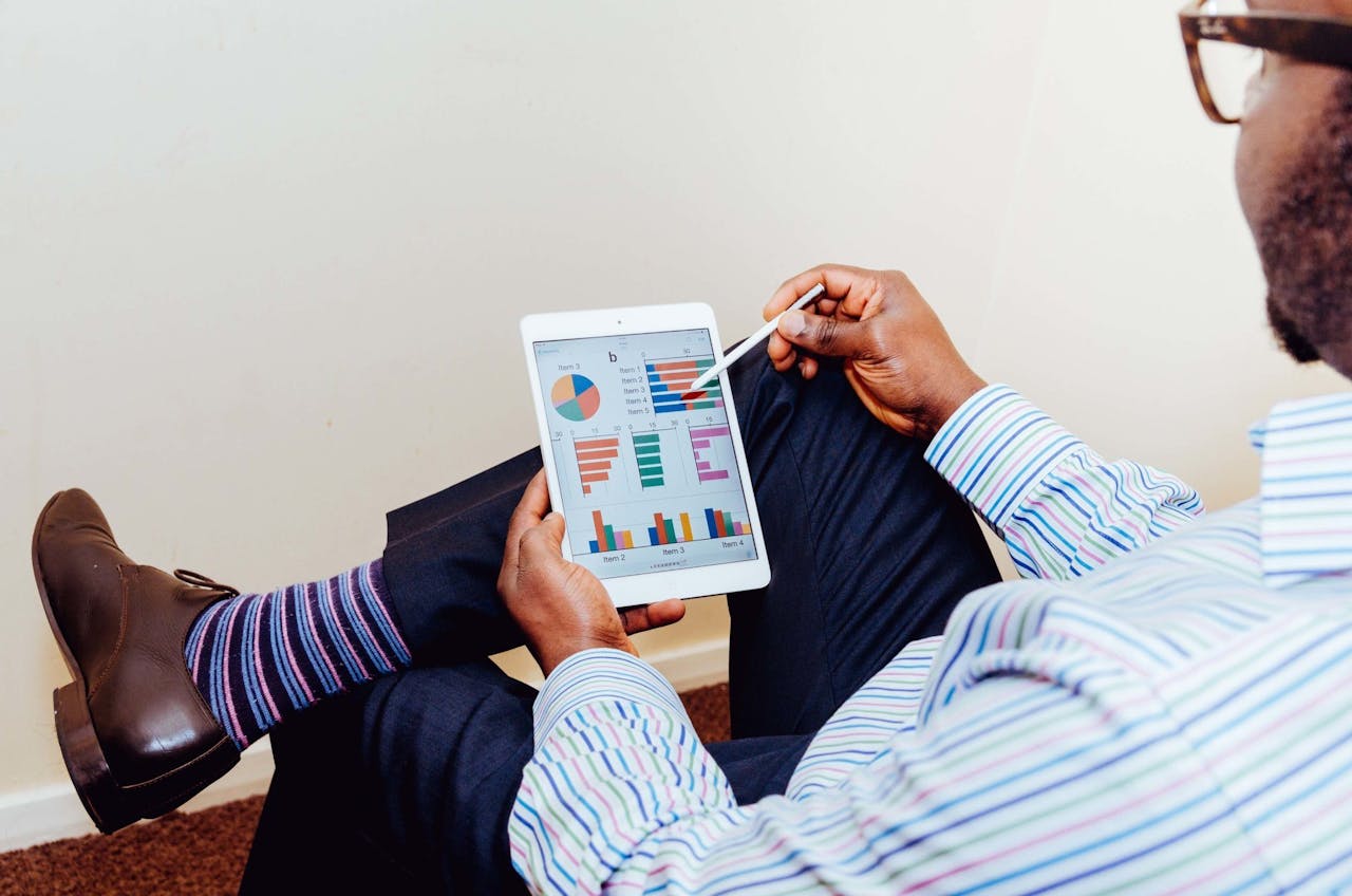 services-04 Businessman using a tablet for data analysis in a relaxed office setting.